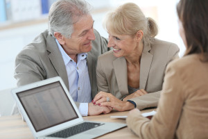 Senior couple meeting financial adviser in office